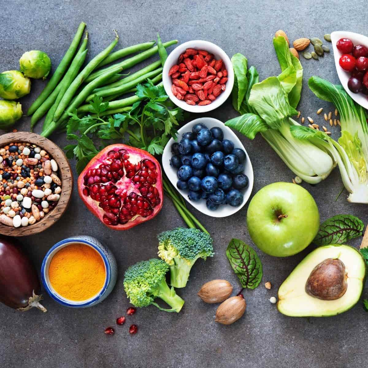 Fruits, vegetables, seeds, and spices on a table.